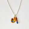 Lego palette and paint brush toy charms hanging of a sterling silver chain. Palette has light blue, dark blue , yellow and black paint like palette Vincent would have used for his Starry Night Master piece painting
