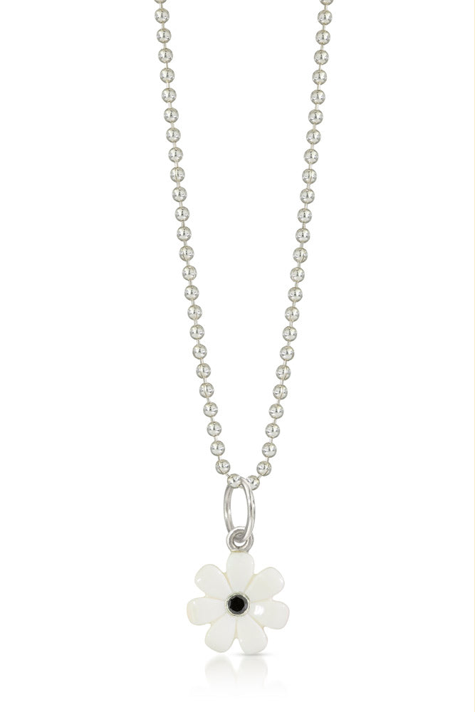 Small white lego flower charm with a black diamond in the center  hanging on a bead chain