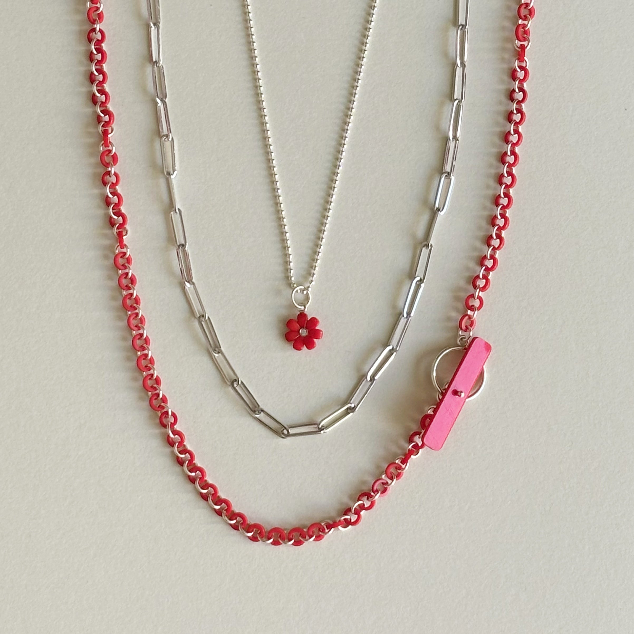 3 chains displayed together as if around the neck to show how well they layer together at different lengths and look pretty styled next to one another.
