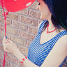 LEGO jewelry worn by a model with red LEGO bracelet and 2 X 2 red LEGO pendant