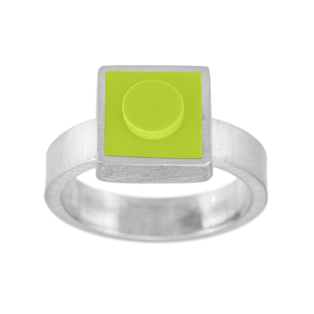Light green 1 X 1 square LEGO brick inset into metal on top of a ring