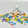 Sterling silver ring with LEG0 mini-figure vanilla cupcake accessory toy on top of ring displayed on colorful heart shaped sprinkles