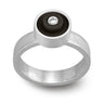 Black LEGO ring with a LEGO dot on top, set in sterling silver with a diamond in the middle on a band with a matte finish
