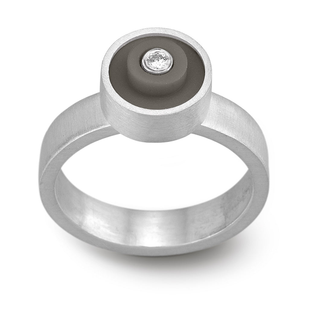 Ring with a dark grey round lego dot on top with a diamond set into the center