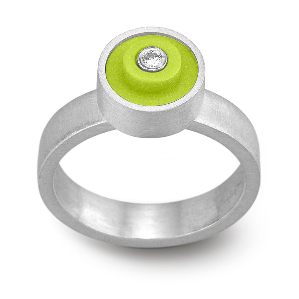 light green lego ring with a round lego dot on top, set in sterling silver with a diamond in the middle on a band with a matte finish