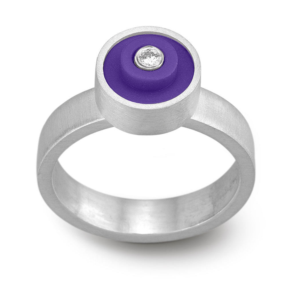 Ring with a purple round lego dot on top with a diamond set into the center