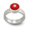 Red LEGO ring with a LEGO stud on top, set in sterling silver with a diamond in the middle on a band with a brushed finish