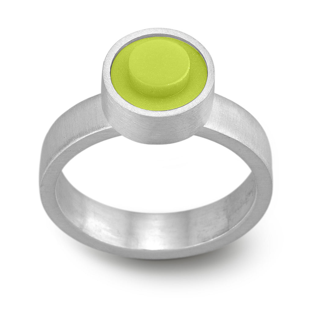 Lime green LEGO brick set into a sterling silver hand fabricated modern ring