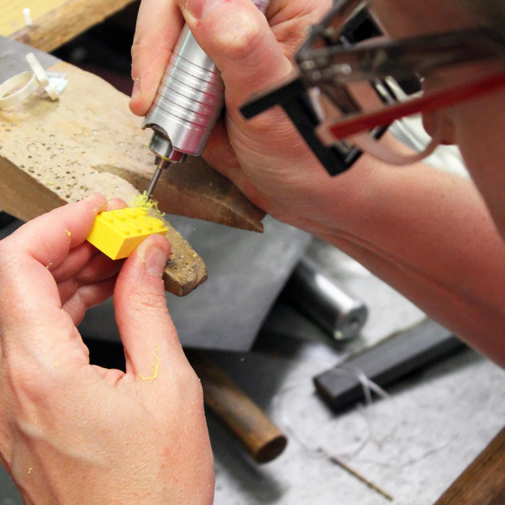 LEGO Designer drilling into a LEGO fabricated jewelry from LEGO