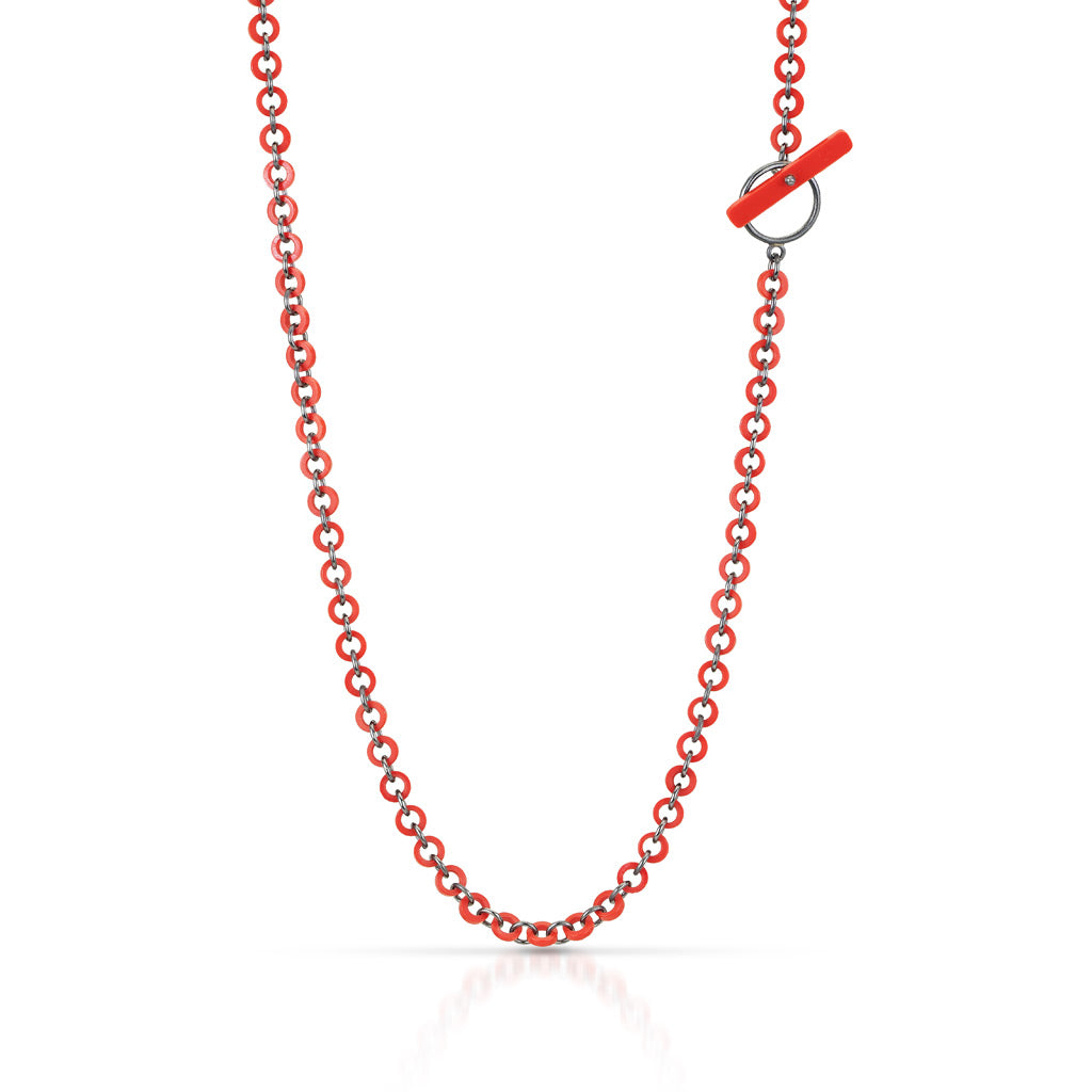 A chain hanging made with cut pieces of LEGO bricks that form tiny circles connected by sterling silver. jump rings Clasp is a long piece of LEGO creating the clasp to be used as a design element