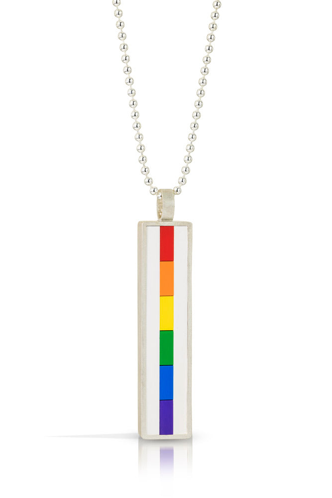 vertical pendant with the side profile of LEGO bricks set into a sterling silver bezel from red , orange, yellow, green ,blue and  purple forming the Rainbow colors in order and  hangin off a bead chain