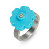 a sterling silver ring with a turquoise LEGO flower piece on top with a diamond set in the middle