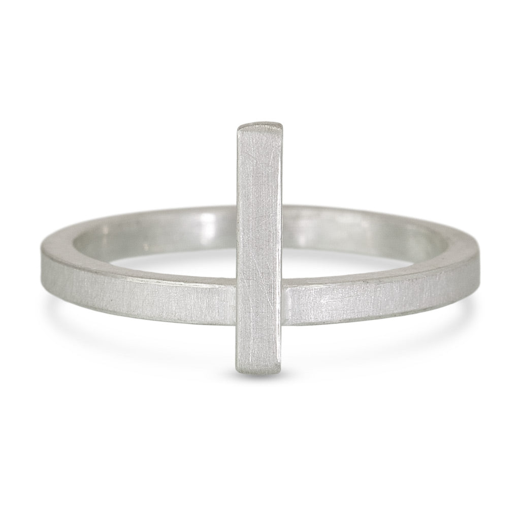 a sterling silver ring with a vertical bar across it to lay next to another ring once stacked next to it