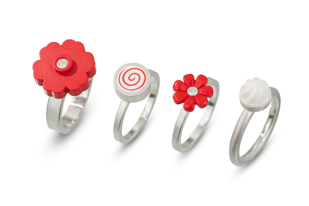 4 rings grouped together for fun statement jewelry. Made with sterling silver, diamonds and LEGO flowers and LEGO dots