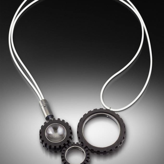 Contemporary and modern necklace with LEGO truck tires. Hand fabricated sterling silver  with patina and photo-etching finish