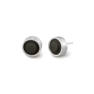 Pair of round black LEGO dot earrings set into silver on a white background