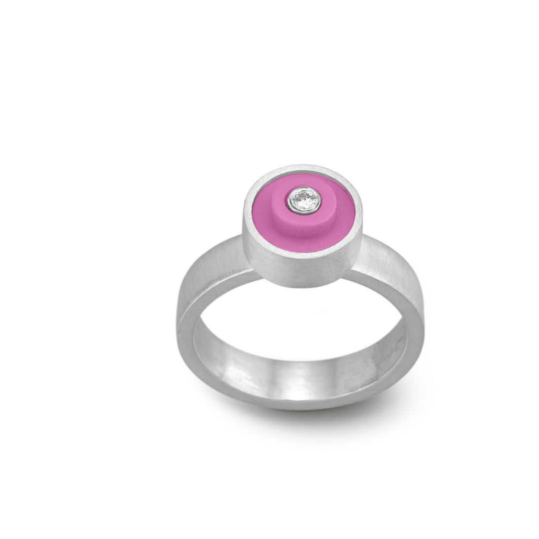 Ring with a hot pink round lego dot on top with a diamond set into the center