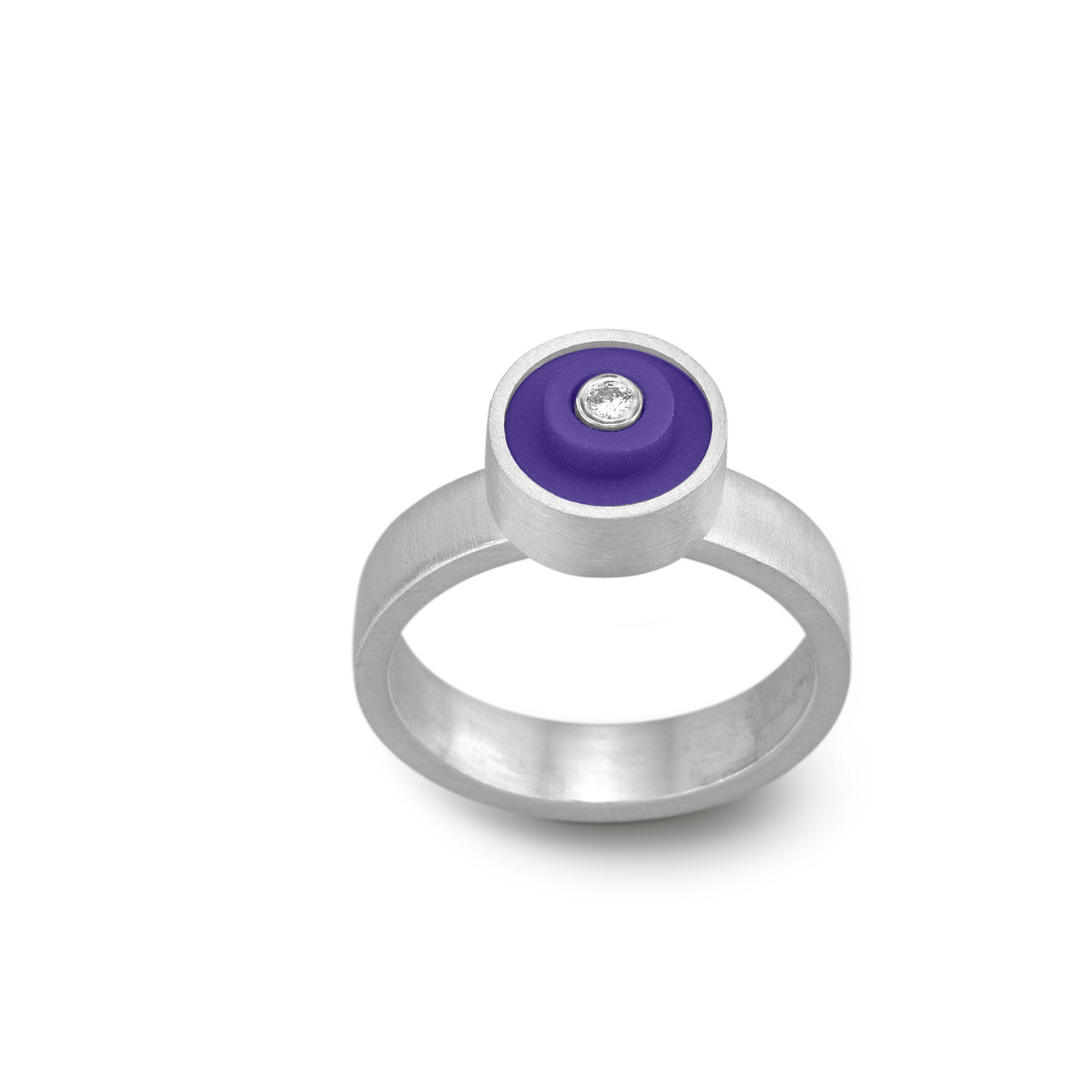 Ring with a dark purple round lego dot on top with a diamond set into the center