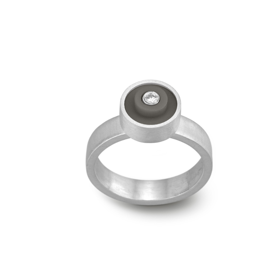 Ring with a dark grey round lego dot on top with a diamond set into the center