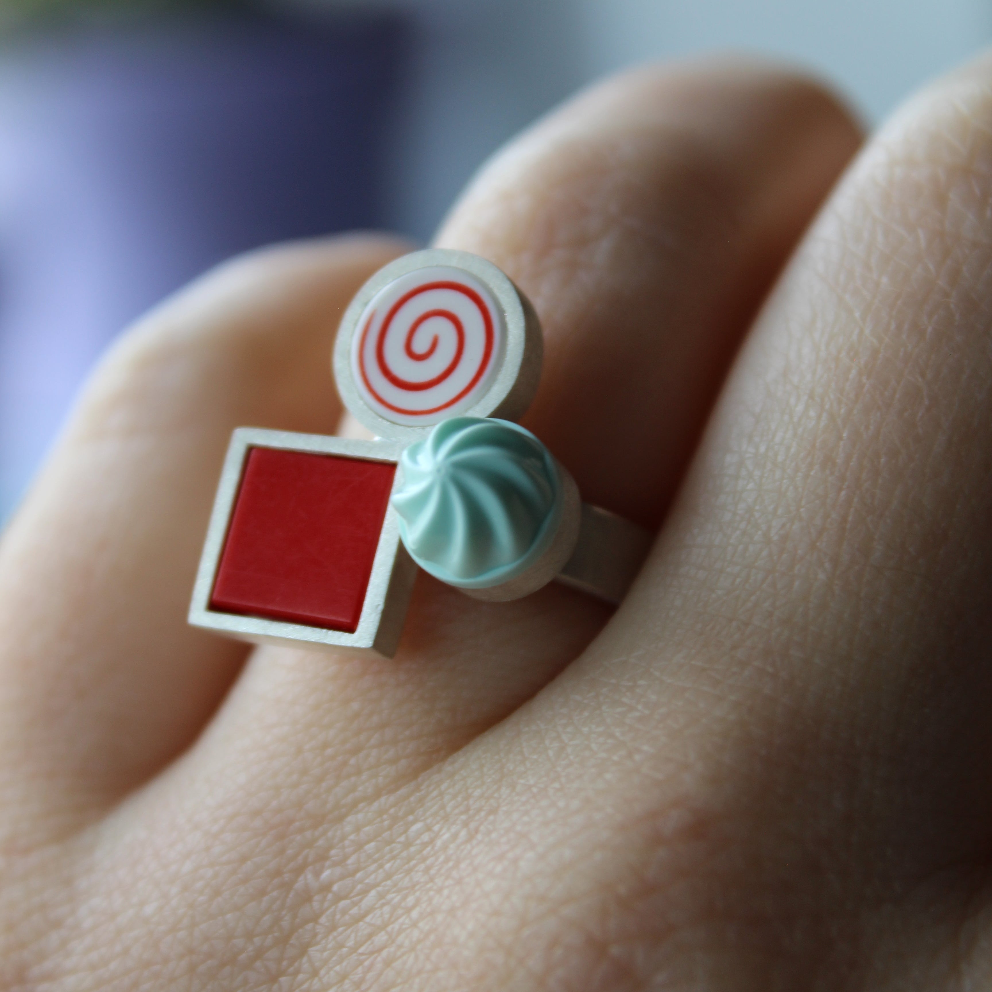 Ring with colorful candy-themed design made from LEGO pieces on a blurred background