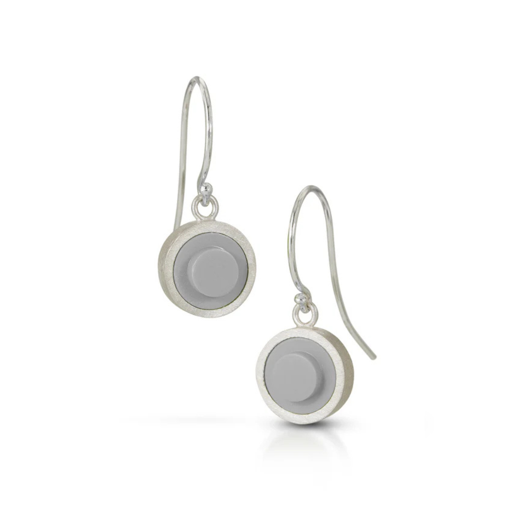 Silver earrings with gray circular LEGO studs on a white background