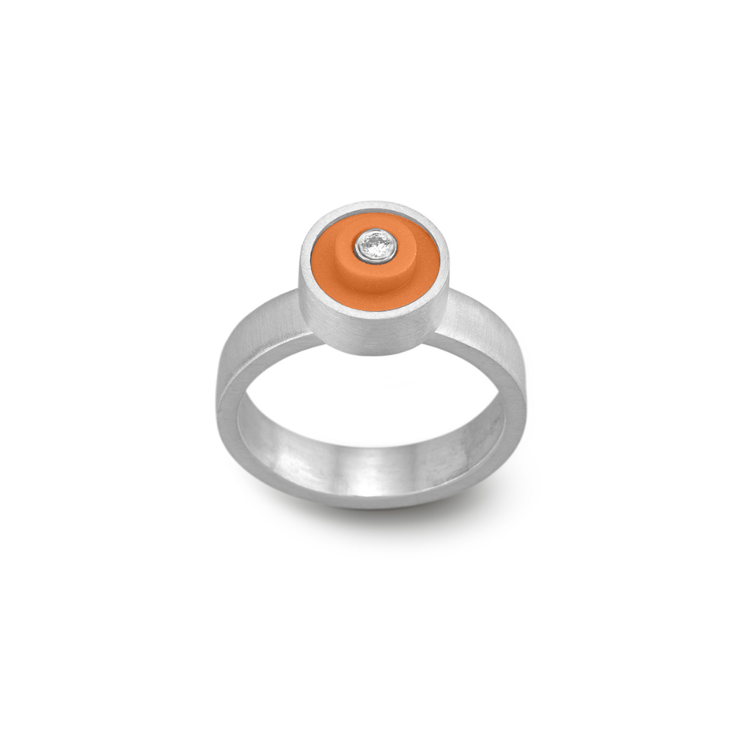 Sterling silver hand fabricated ring with an orange round lego dot on top with a diamond set into the center