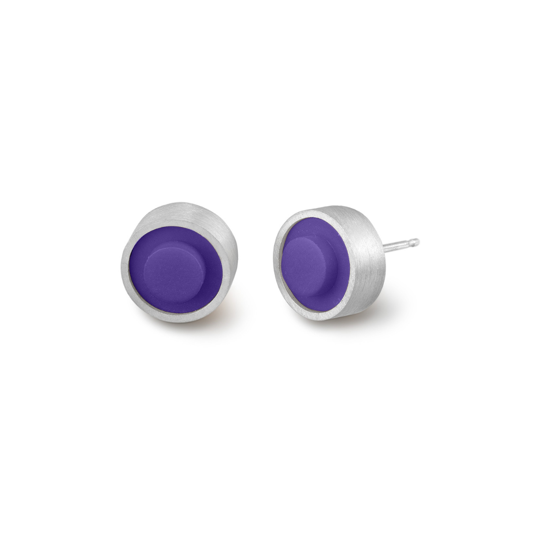 Pair of round purple LEGO dot earrings set into silver on a white background