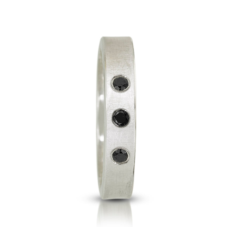 sterling silver band shown standing up with 3 black diamonds set flush into silver 