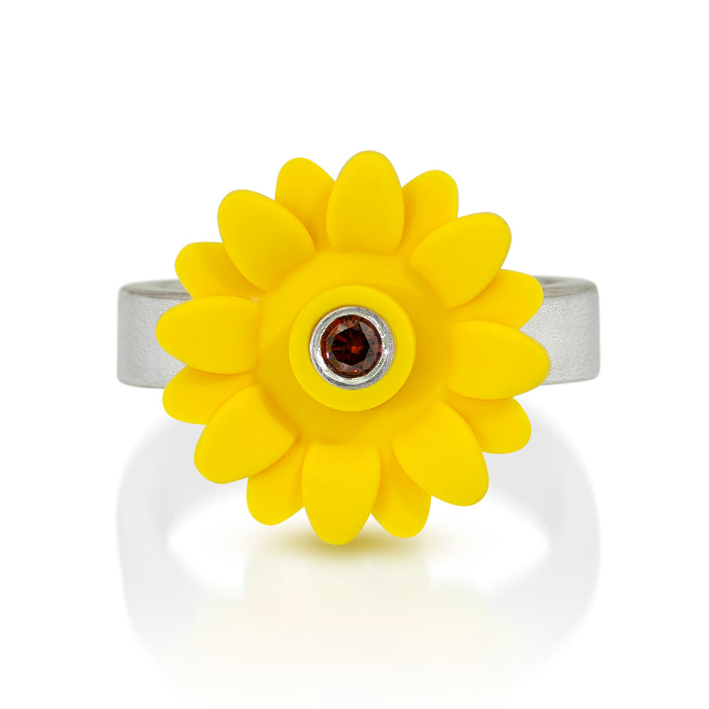 Yellow sunflower  mounted on top of a silver band with a brown diamond set in the center