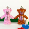 Colorful teddy bear charms with building block toys on a white background