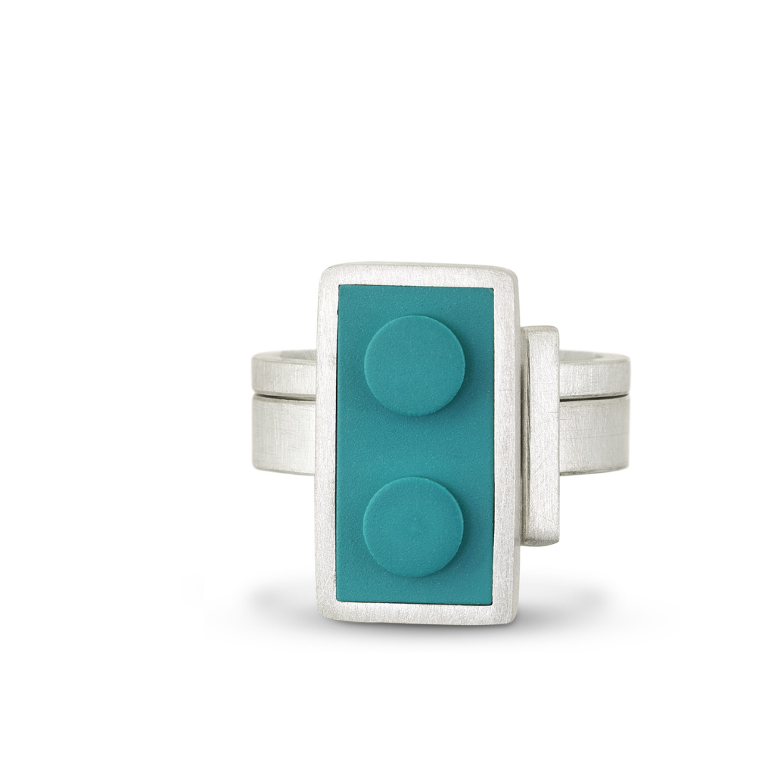 1 X 2 LEGO set into a sterling silver ring with a stacking bar ring that sits along side to define the straight line of the LEGO brick 