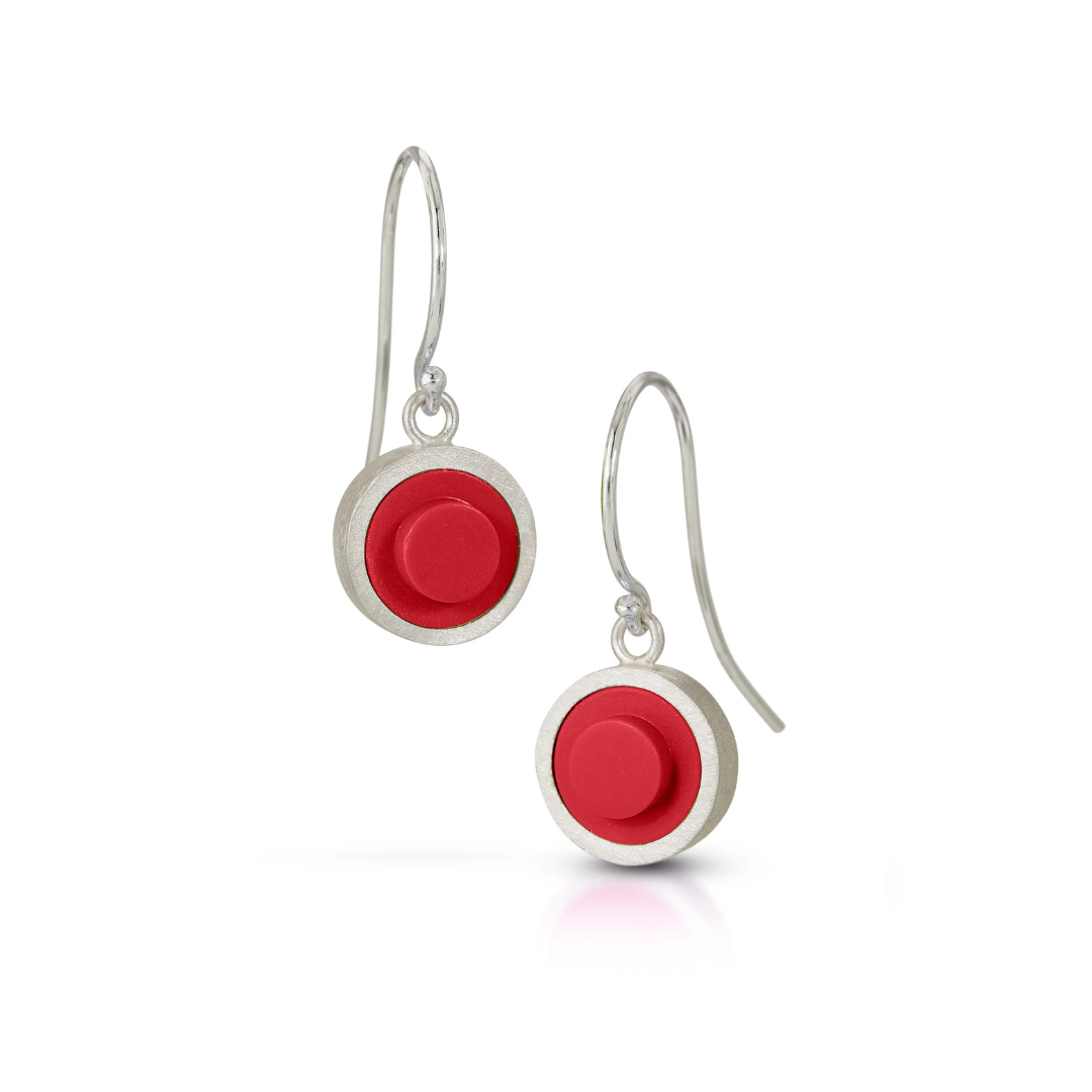 Silver earrings with red circular LEGO studs on a white background