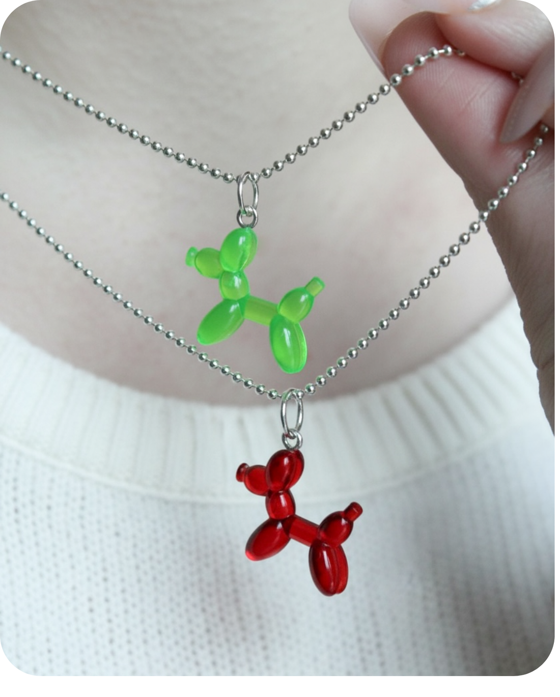 3 little transparent LEGO mini figure balloon dog charms that look like they are dancing in red, blue and purple