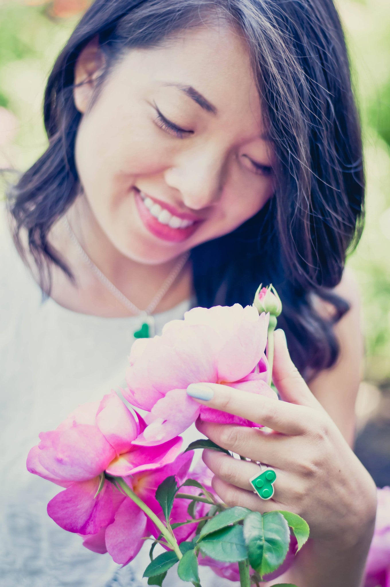 Model wearing Portland heart pendant and ring made from  2 X 2 green LEGO bricks