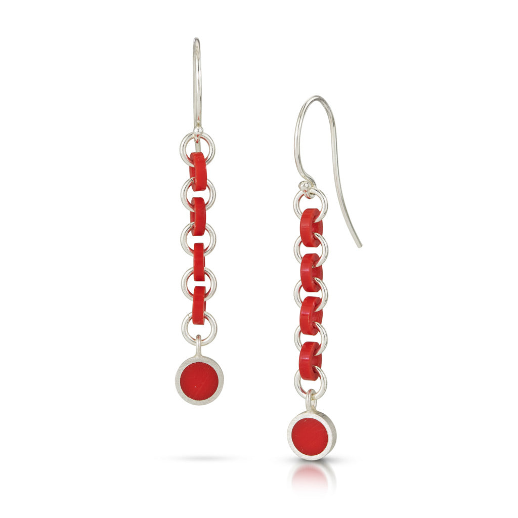 Dangle earrings with alternating round silver rings and round red rings. At the bottom of rings there is a red circle 