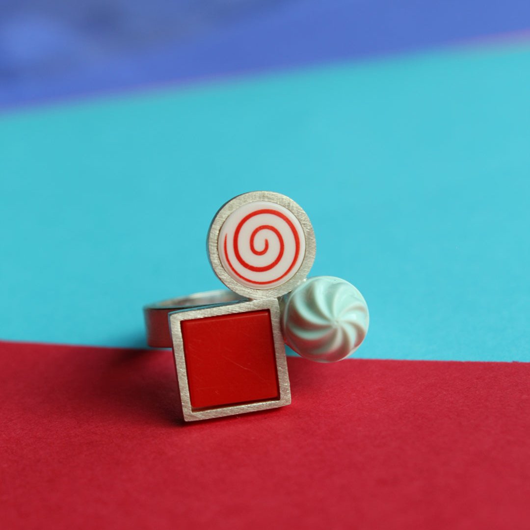 Ring with colorful candy-themed design made from LEGO pieces on a blurred background