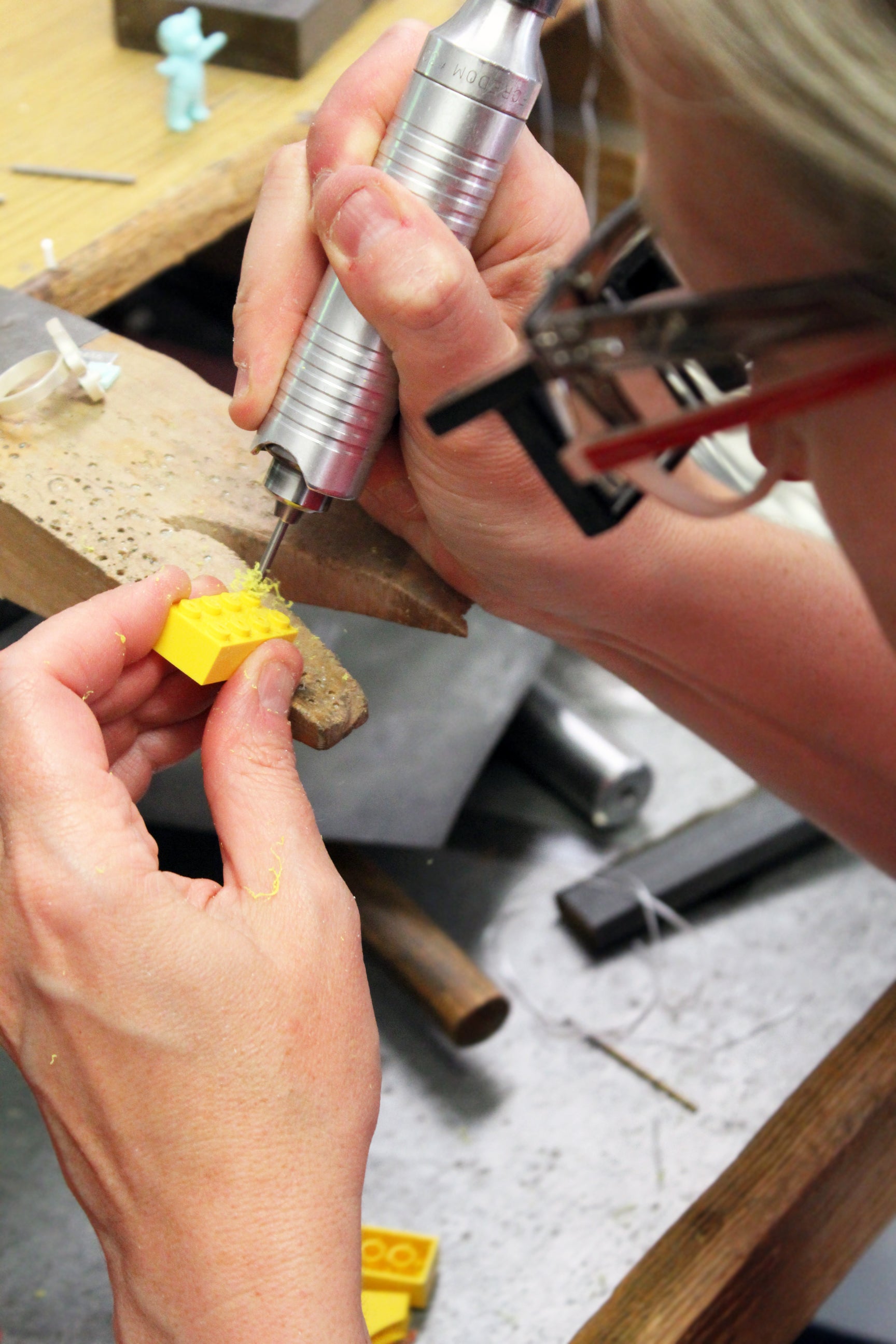 LEGO Designer drilling into a LEGO fabricated jewelry from LEGO