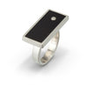 Modern design ring with side profile of black LEGO brick with diamond set flush into it.