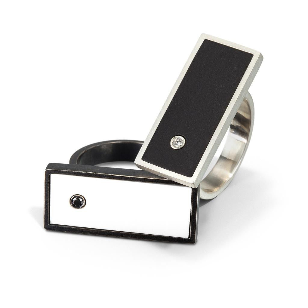 Two rings shown. One with the side of a white LEGO brick with a black diamond and the other with the side of a black LEGO brick with white diamond