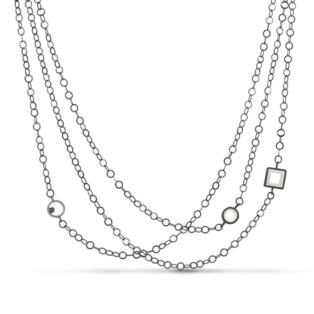 Sterling silver necklace with 3 stranda of circle links with fun LEGO pieces and a black diamonds inside circle links