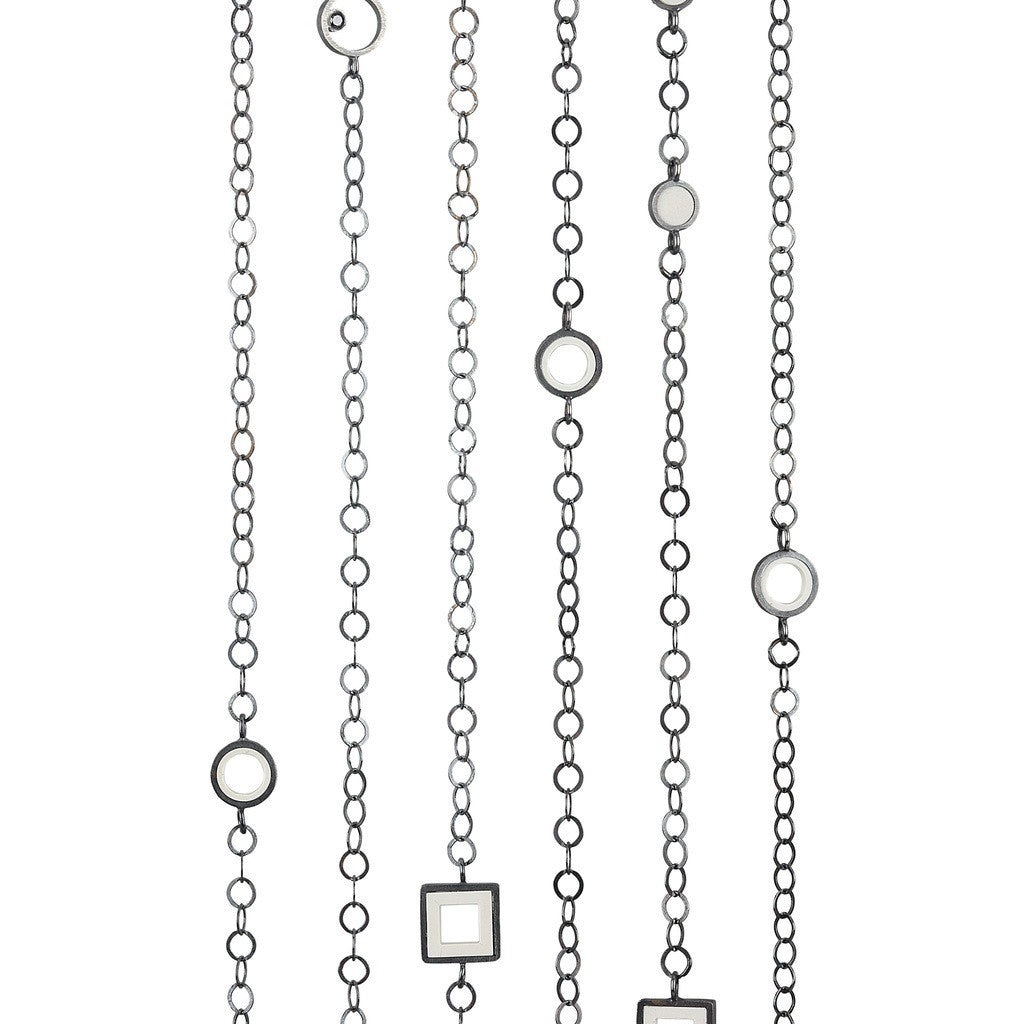 Sterling silver necklace strands  displayed in a row with fun LEGO pieces