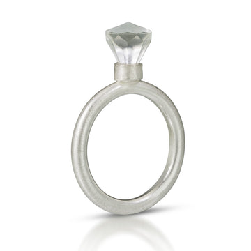 sterling silver ring with a rounded band with a  LEGO toy gem set on top.