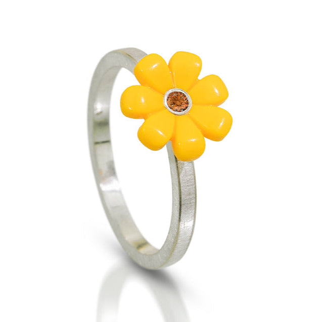 Yellow LEGO daisy  toy piece on top of a silver ring with a champagne diamond in the center