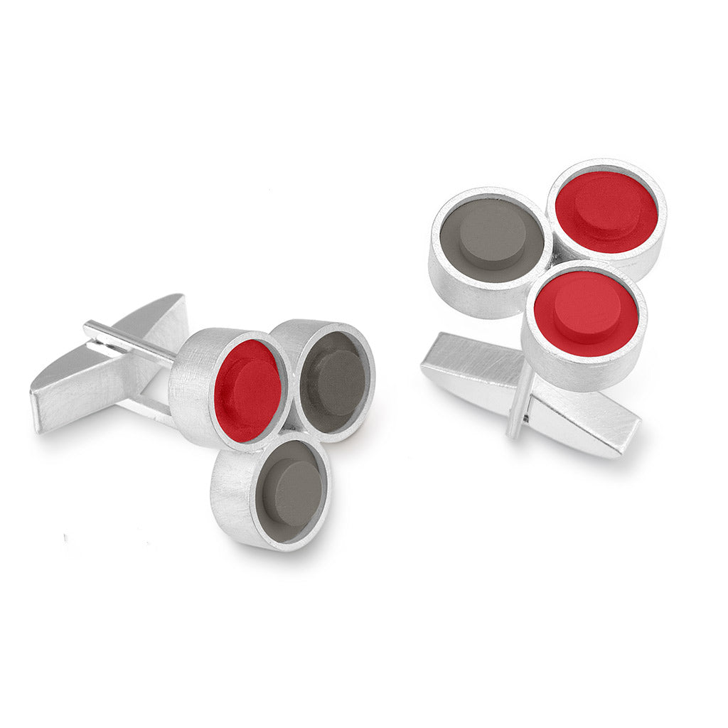 A pair of sterling silver cufflinks with 3 LEGO round studs in red and grey
