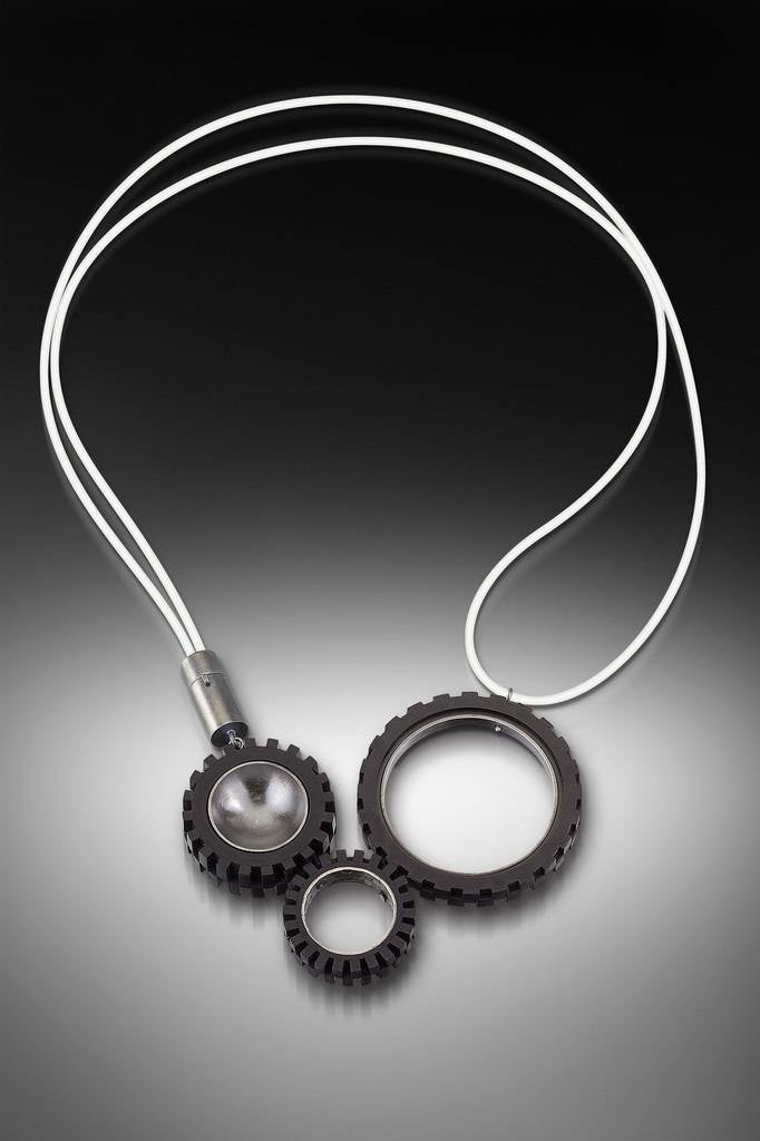 Contemporary and modern necklace with LEGO truck tires. Hand fabricated sterling silver  with patina and photo-etching finish