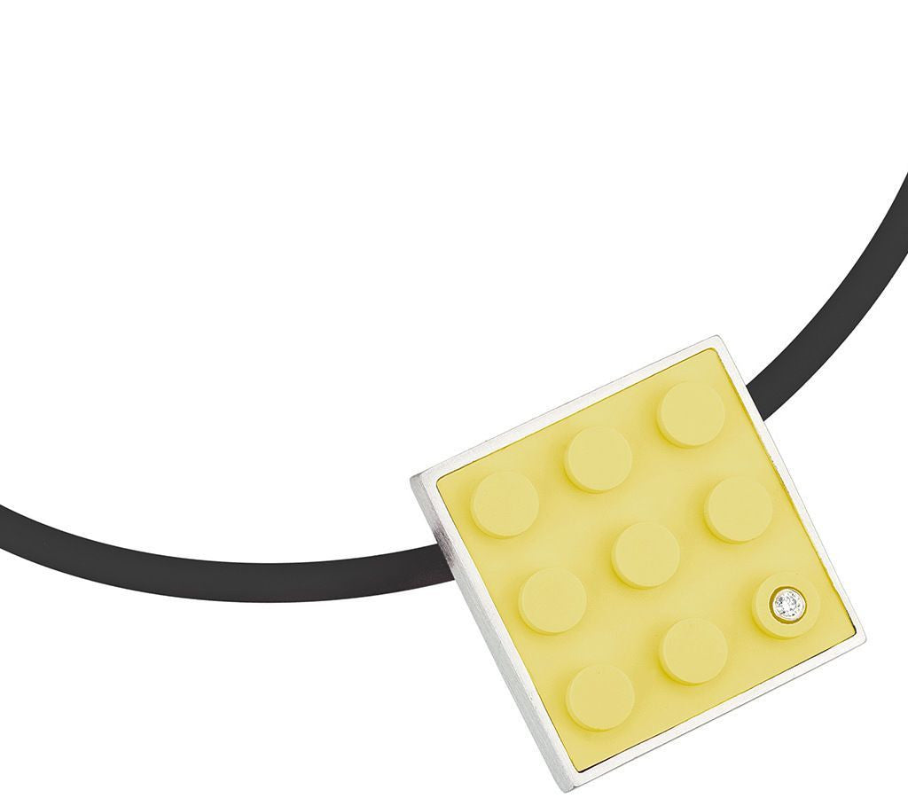 Yellow LEGO plate made into pendant with diamond set into sterling silver on rubber cord